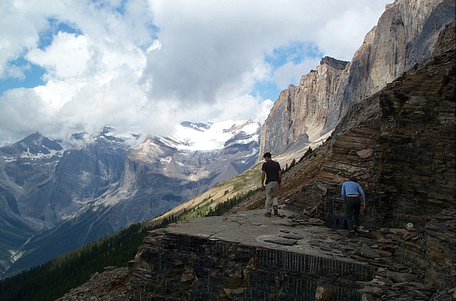 Figure 21.9 The Cambrian Burgess Shale at the Walcott Quarry, Yoho Park, B.C., with Wapta Mountain in the upper right. [SE]