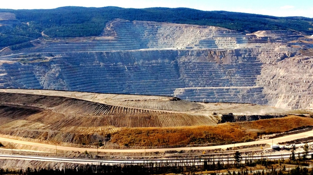 Figure 20.1 The open pit (background) and waste-rock piles (middle) of the Highland Valley Copper Mine at Logan Lake, British Columbia [Photo by Russell Hartlaub, used with permission]