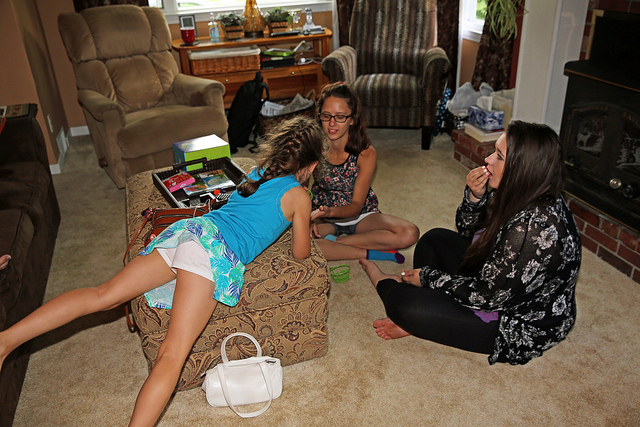 Three girl cousins playing a game together during a family visit