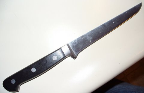 image of a boning knife with a sharp point and a narrow blade