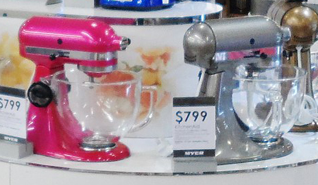 image of two mixers siting on a counter; they have hinges to allow the beaters to rise out of the mixing bowl
