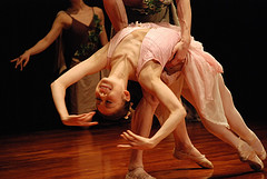 photo of ballet dancer holding another to keep her from falling.