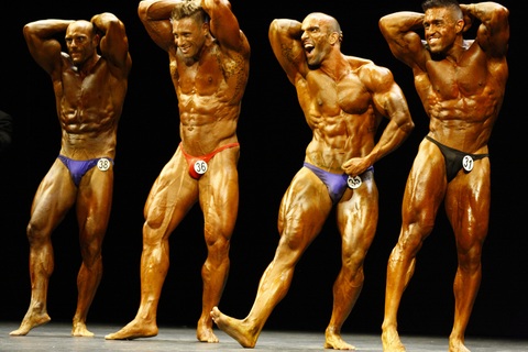 4 men posing in a bodybuilding competition