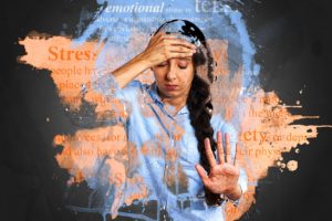 Image of a woman holding forehead with one hand and her other hand is in front of her. The words stress, emotional, and anxiety surround her.