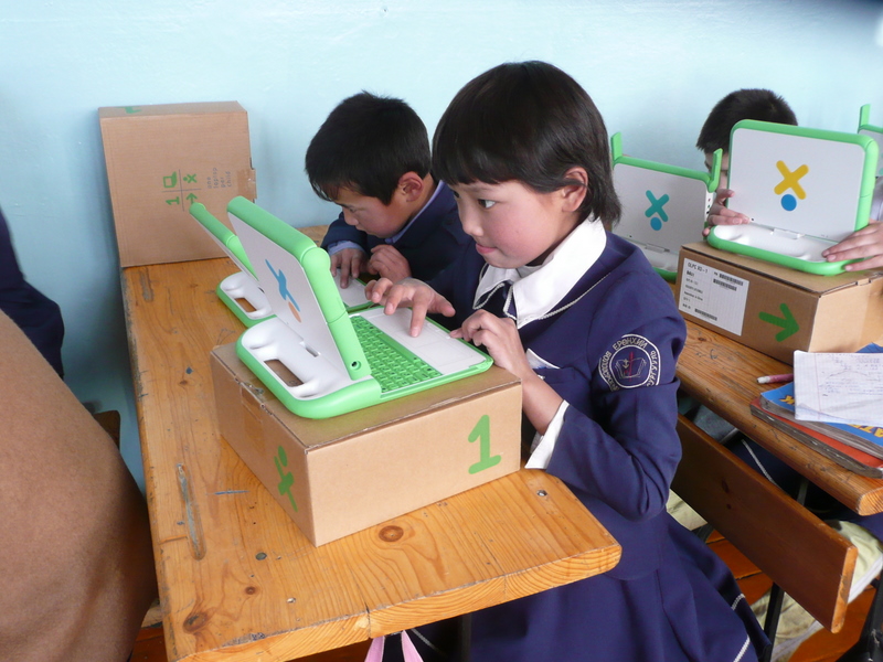 Image of young children working at laptops