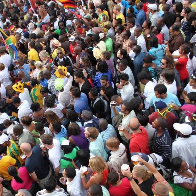 A huge crowd of people stand shoulder to shoulder during the 2010 World Cup.