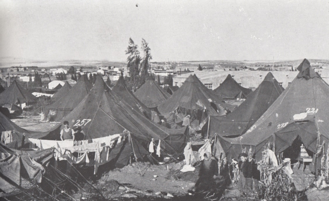 Black and white photo of a tent encampment.