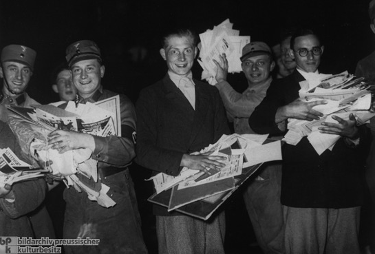 Students carry books and pamphlets by Jewish and left-wing writers to be burnt in a gigantic bonfire. They took part in the so-called Rally against the Un-German Spirit.