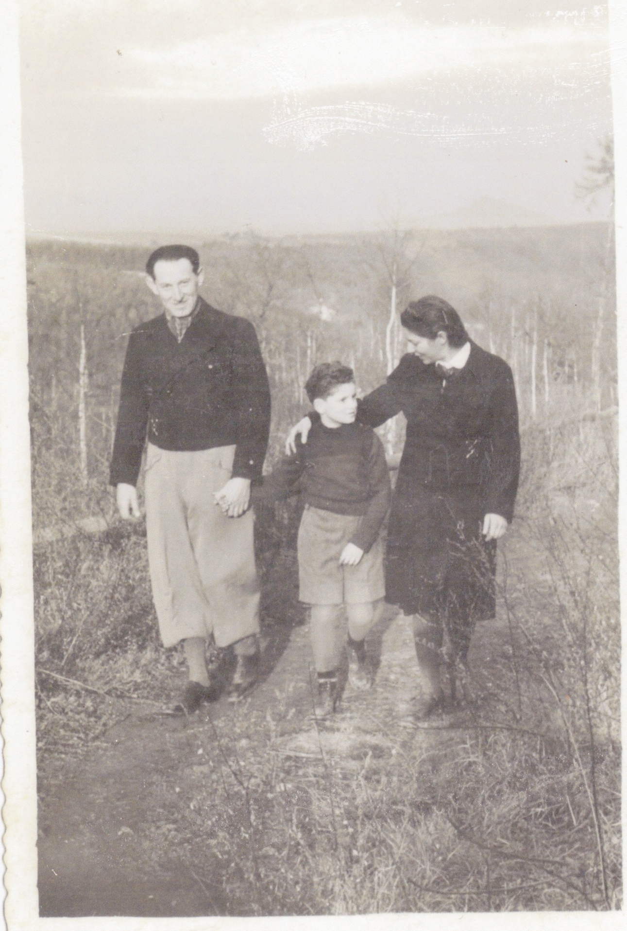 A photo of Paul and Kmaila Rosen walking with their son.