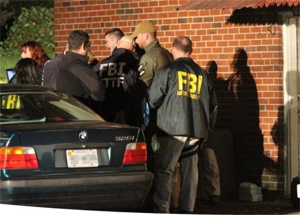 Photo of FBI agents next to a building.