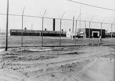 photo of parchman prison through the barbwire fence.