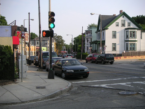 View of an intersection in Boston, Massachusetts. Run down buildings with lots of cars