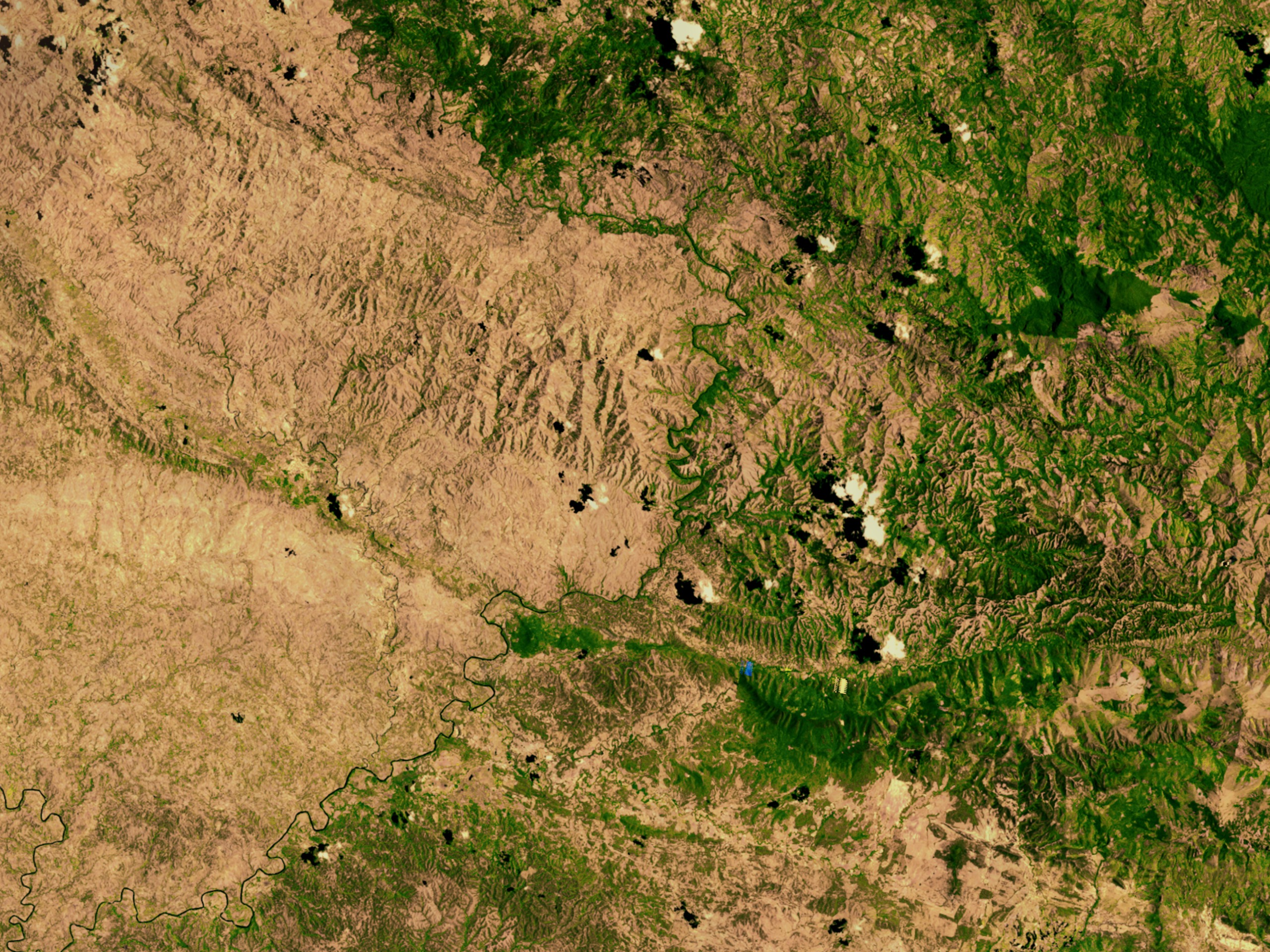 Green Forested Domincan Republic and Brown Deforested Haiti as viewed from space.