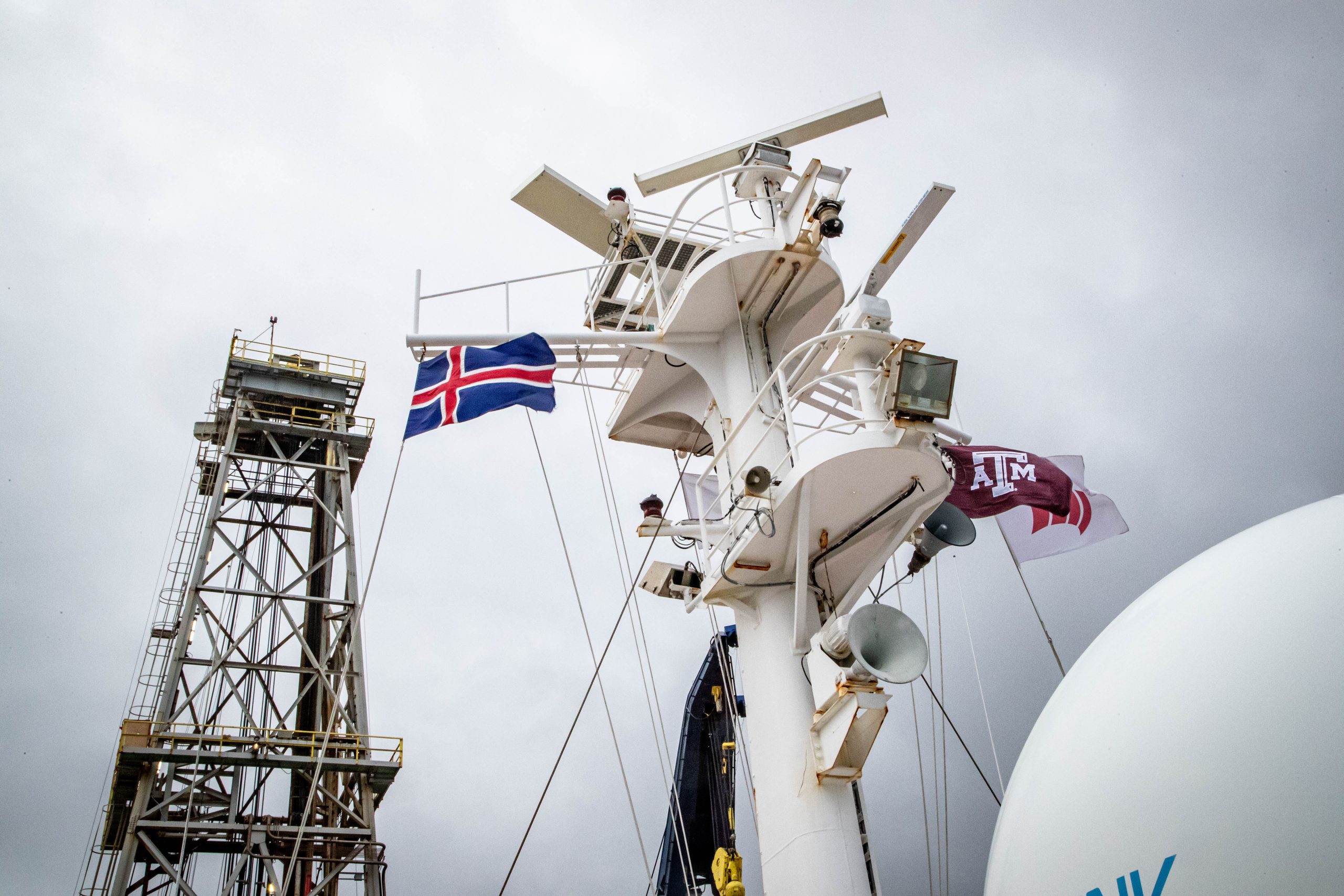 flags flying on the mast of a ship