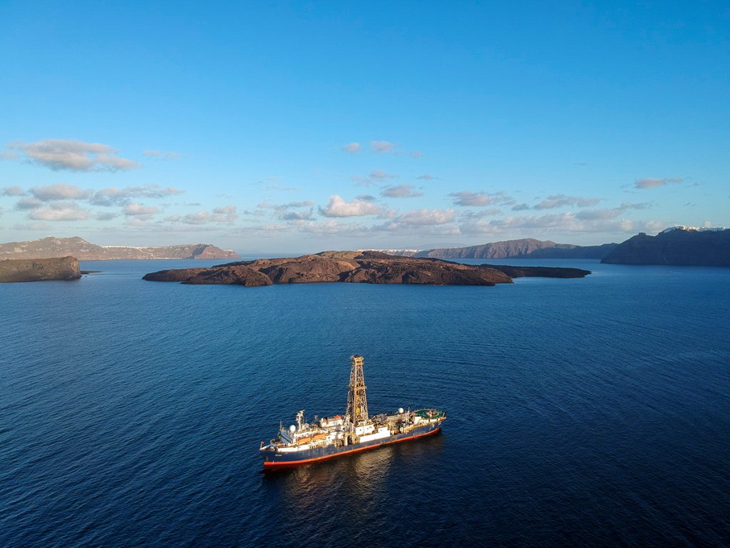 Ship on the water in a volcanic caldera