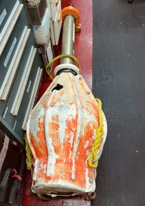 acoustic beacon lying down on a ship deck