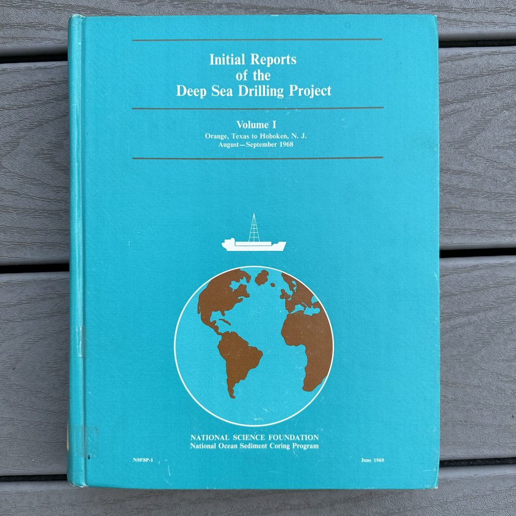 turquoise book cover with white lettering and a sketch of Planet Earth