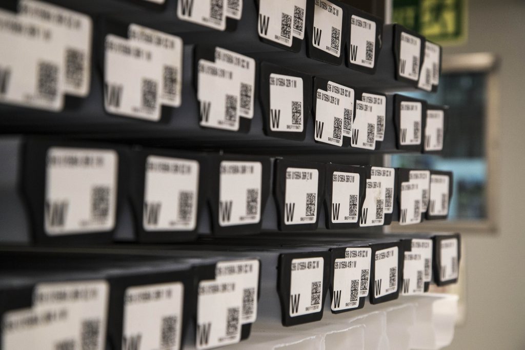close up photo of many black caps with white labels and black barcodes