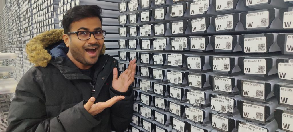 Man standing in front of black capped D tubes showing them off withe a smile.