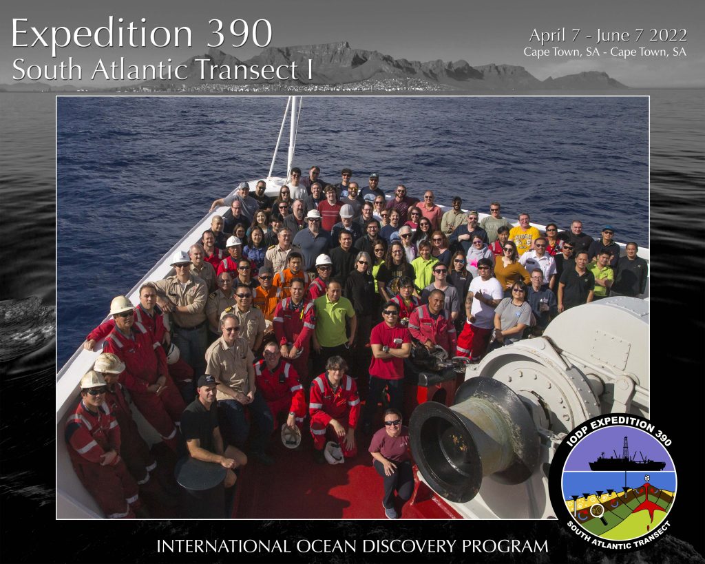 people standing on the bow of a ship on the ocean