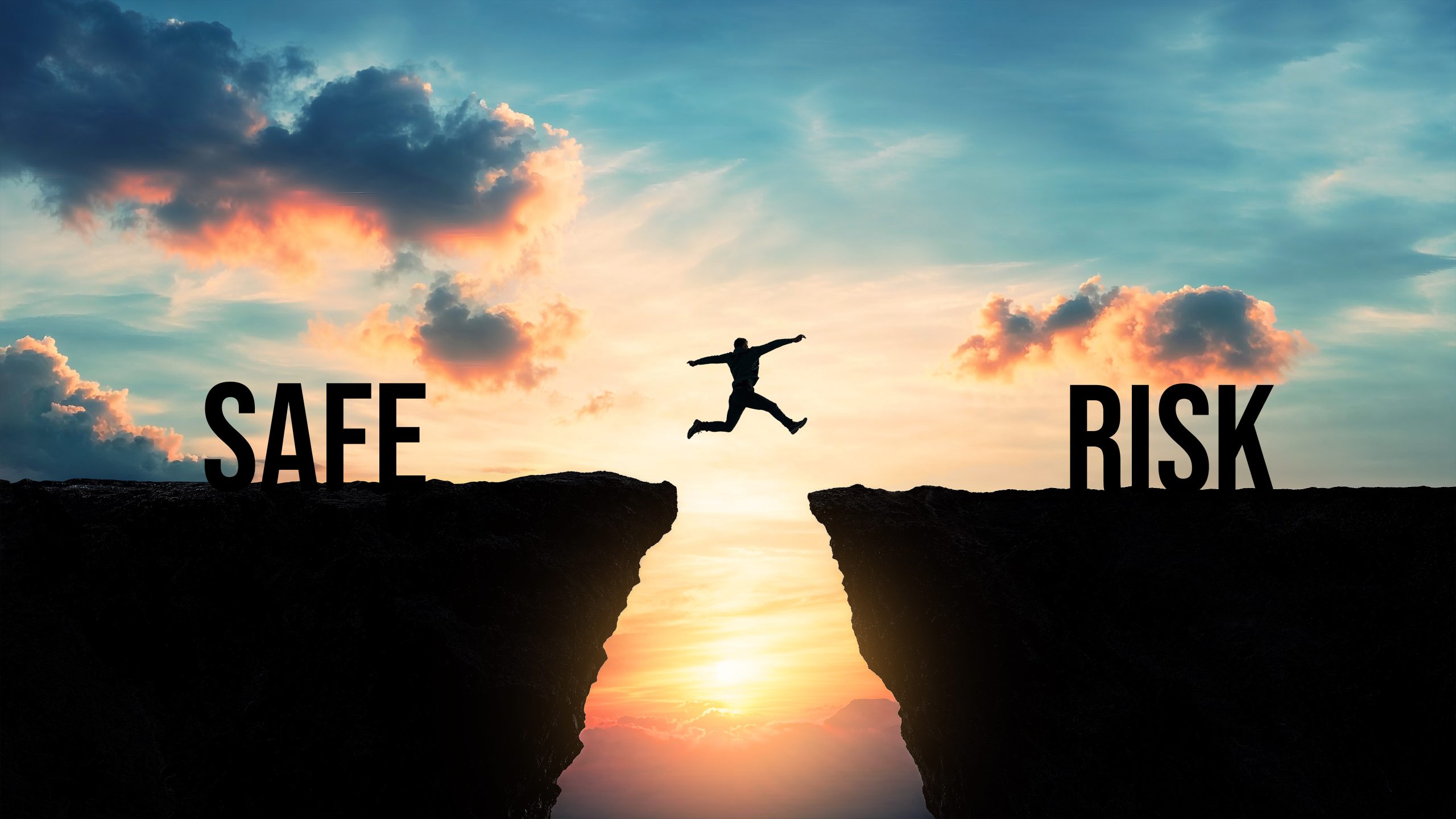 person leaping over a chasm; on the left is the word safe and the person jumps toward the word risk