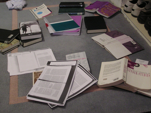 Planning materials sprawled all over the floor as a student preps for an Essay