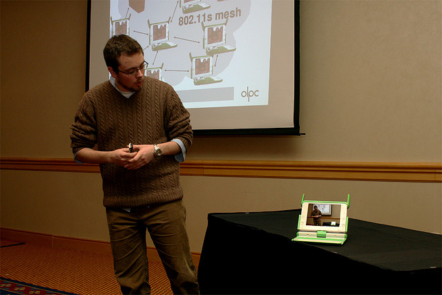A man presenting on a small tablet